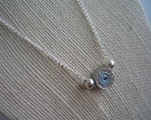 Round blue evil eye charm silver colored chain necklace