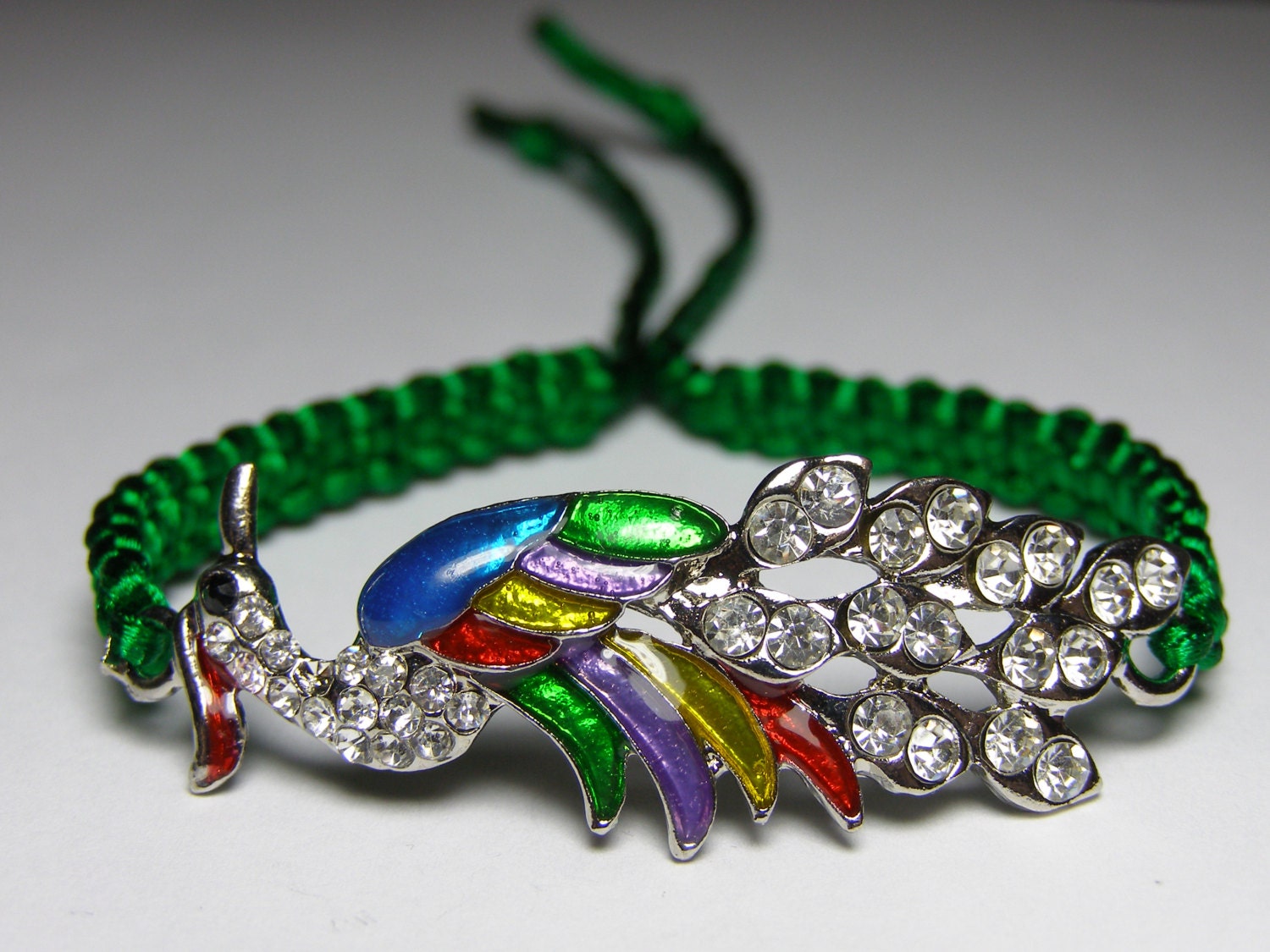 Peacock bracelet with rhinestones  in silver metal and enamel, emerald green nylon cord