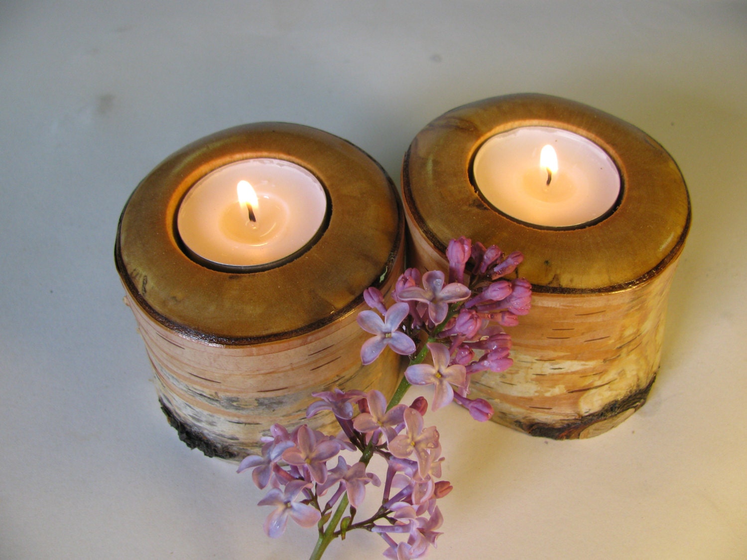 Two woodland tea light candle holders cut from red birch.
