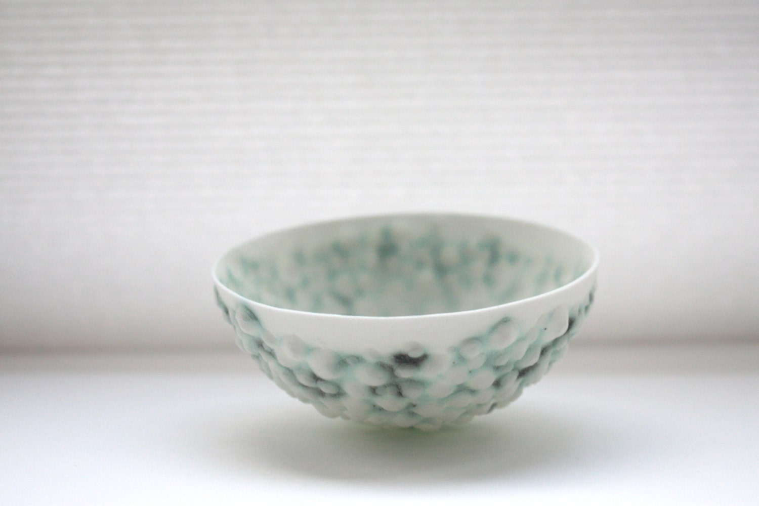 English fine bone china stoneware bowl with a unique textured surface and a hint of green.