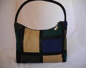 Shoulder bag, ultrasuede with faux leather strap and strips outer11.5"T, 13"W, 3D, 18"drop. Cotton lined, zipper closure, 1 zipper pocket, 2