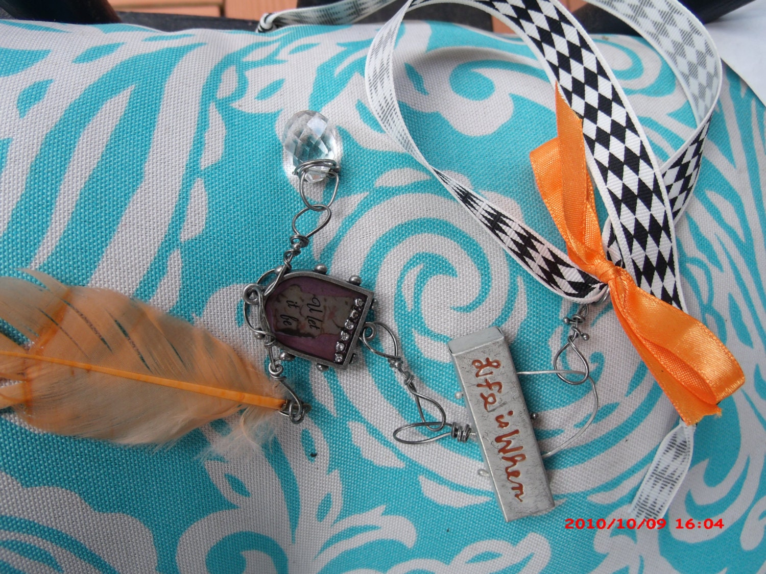 Unique beautiful metalwork necklace Inspirational sayings "Life Is When" with orange feather, square pendant black and white argyle bow
