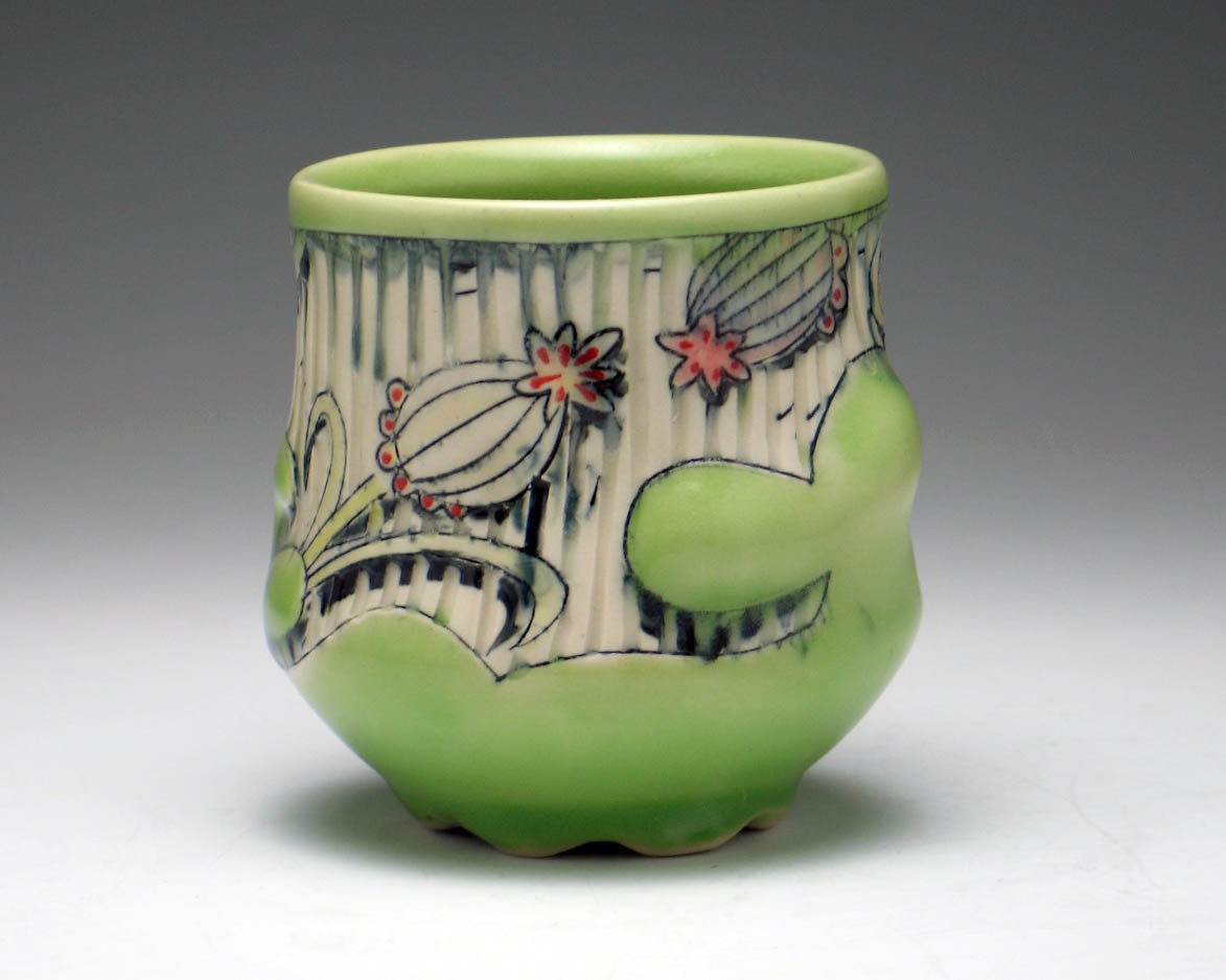 Green Cup with Carved Stripes, Embossed Relief, and Floral Illustrations