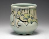 Light Blue Cup with Carved Stripes, Embossed Relief, and Leaf Illustrations