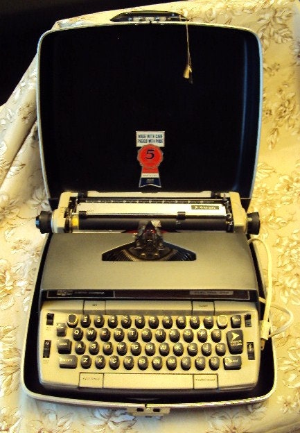 A vintage Smith Corona 210 Automatic electric typewriter in original case, good working condition
