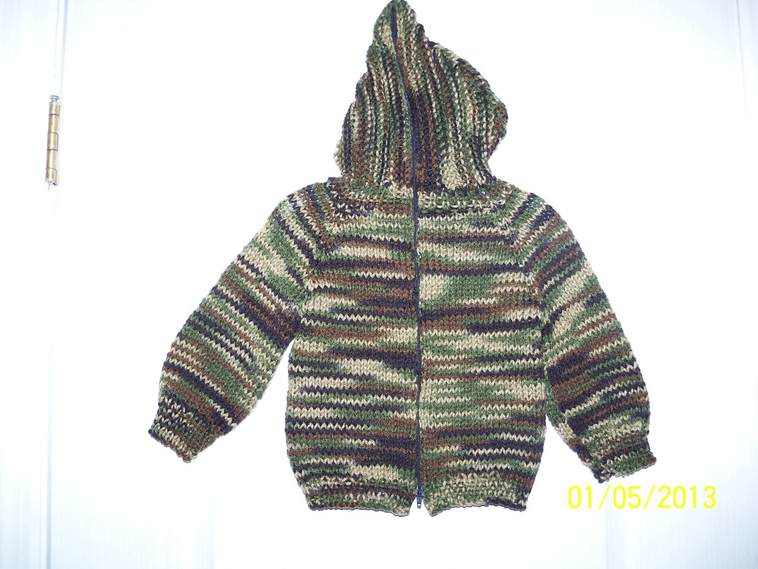 Hooded sweaters with back zipper and cable front.