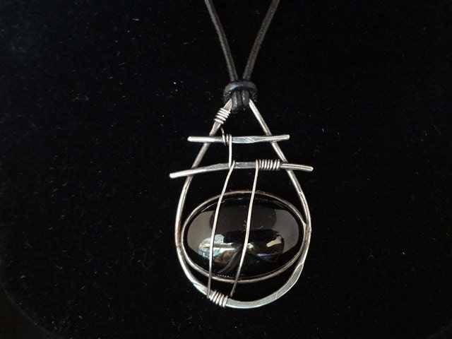 Sterling silver pendant with black onyx cabochon