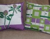 floral and geometric decorative throw pillow, purple and green.