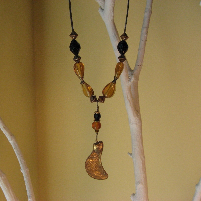 Beaded necklace with brass maple seed pod on waxed cotton cording