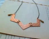 Copper chevron necklace on antiqued brass chain with bullet charms