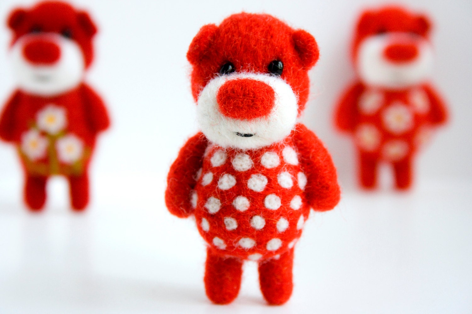 Red needle felted pocket pocket bear with white polka dots
