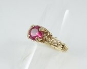 Lab-grown ruby solitaire wire wrapped ring in gold