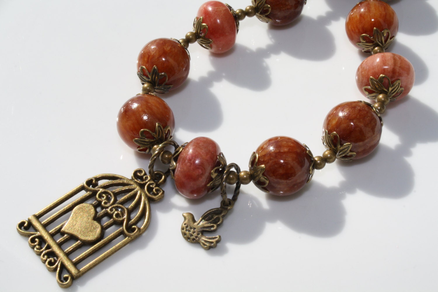 Amber and Rhodonite Bronze Necklace with Heart and Bird Pendant