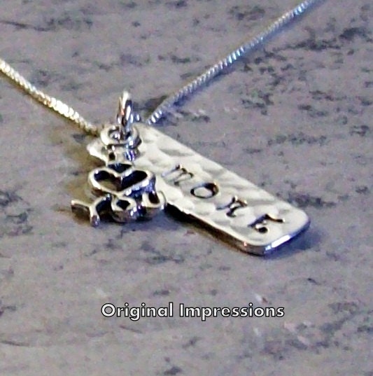 I love you more pendant necklace of solid aluminum with a sterling silver "I (heart) you" charm on a sterling silver chain.