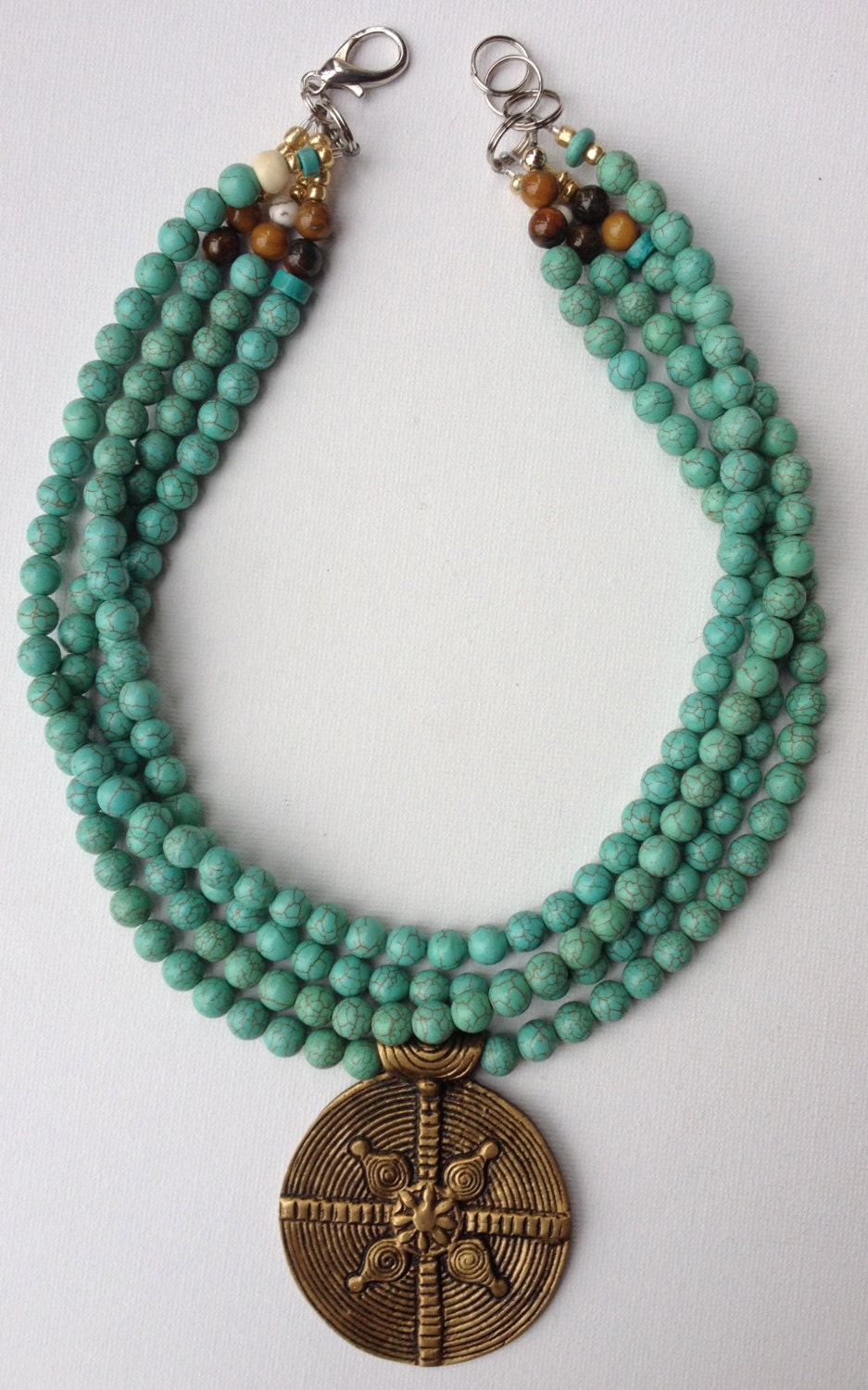 Ravi necklace - turquoise howlite bead neckalce with solid brass Naga tribal pendant