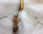 kailey. a single feather earring with red aventurine, mother of pearl, and gold findings.