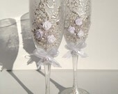 Hand decorated wedding toasting flutes in ivory and white, with fabric roses and bows