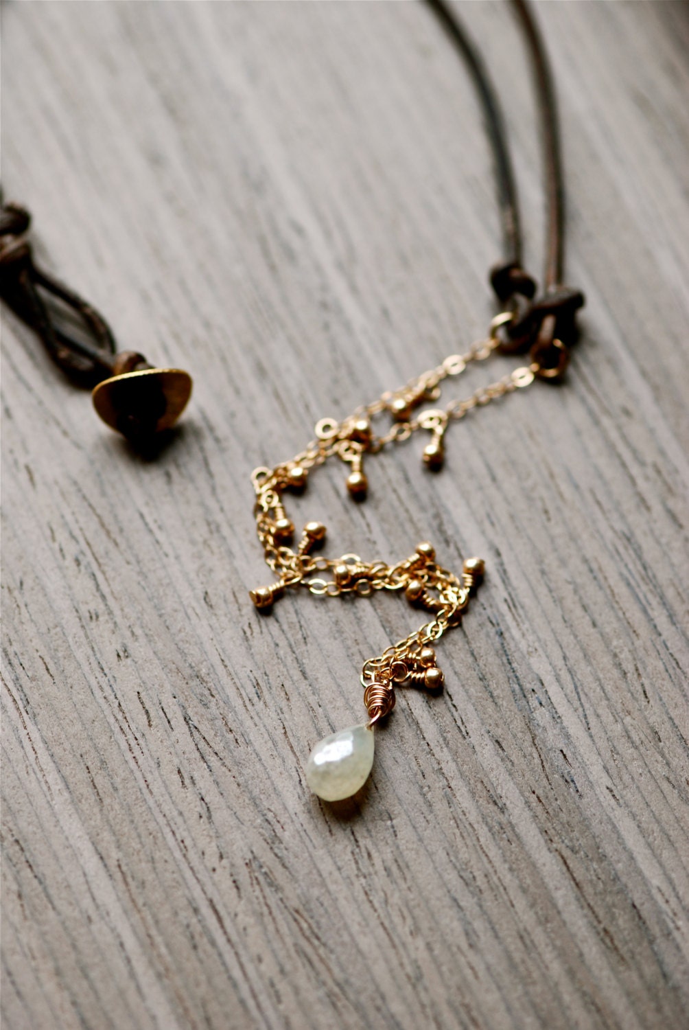 pearlized mirror prehnite briolette and gold dangle necklace in brown leather. handmade jewelry. green. artisan
