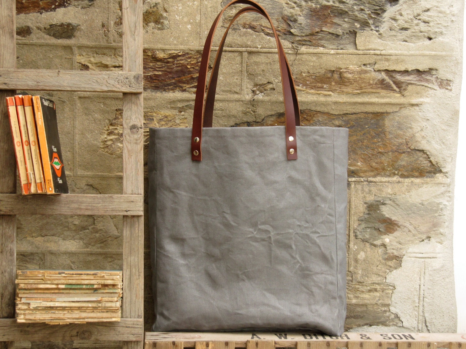Oversized tote. Thick leather straps. Washed grey canvas. Cotton stripe lining.