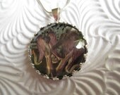 Red Bleeding Hearts Pressed Flower Crown Pendant Atop Black Background Beneath Glass-Symbolizes Undying Love