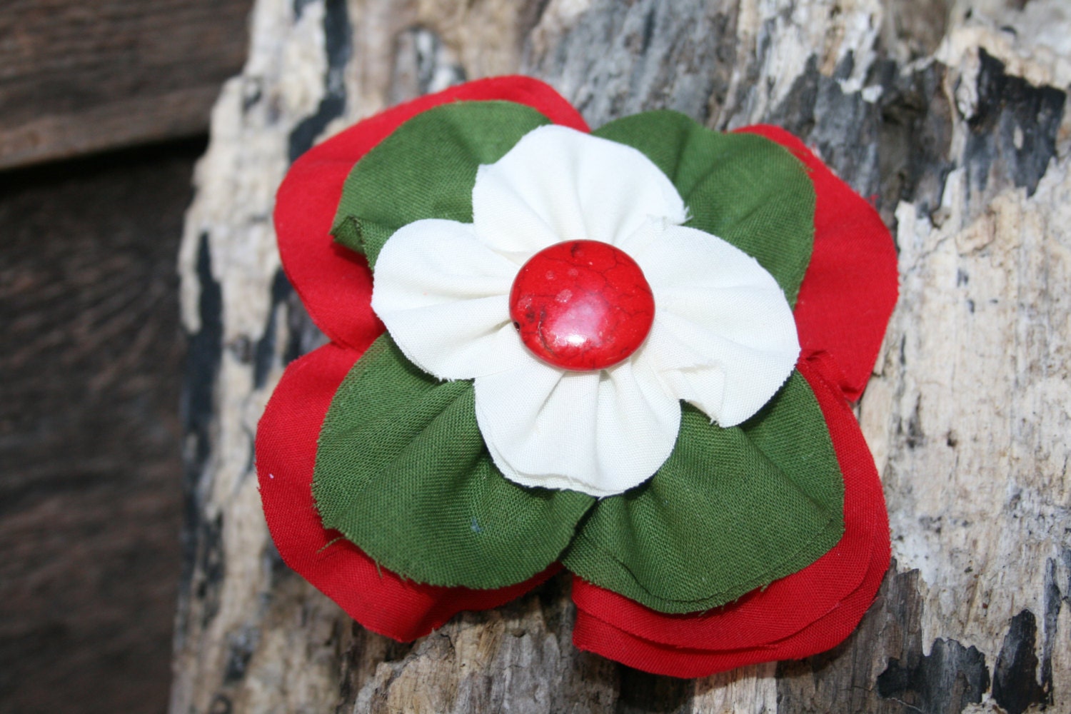 Handmade red, green and cream stacked flower with red button in the middle. - RockabillyBabyPlace