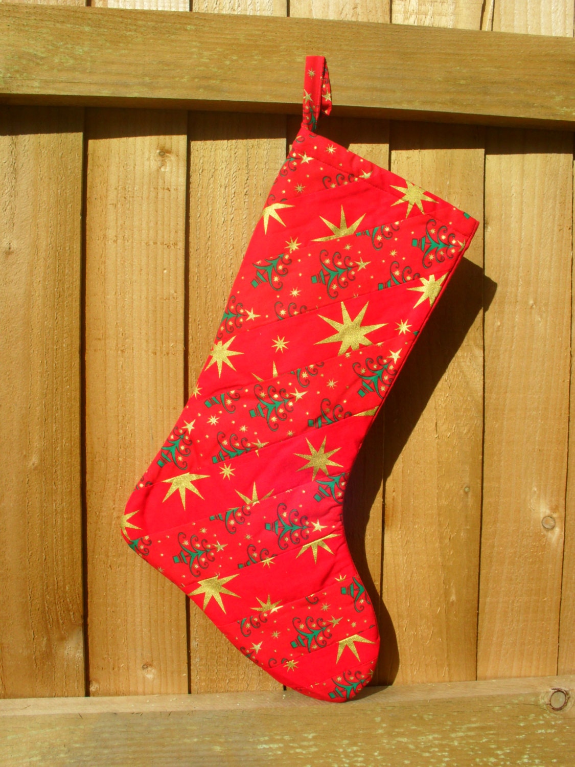 Red stripe Christmas Stocking with Green Christmas trees and gold stars.