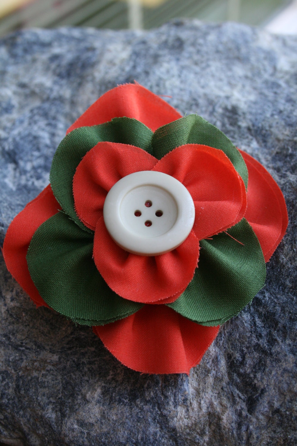 Handmade orange and green stacked flower with button in the middle. - RockabillyBabyPlace