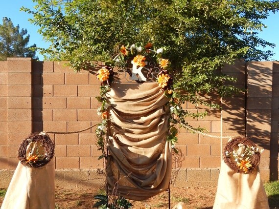 Rustic wedding arch with draped burlap