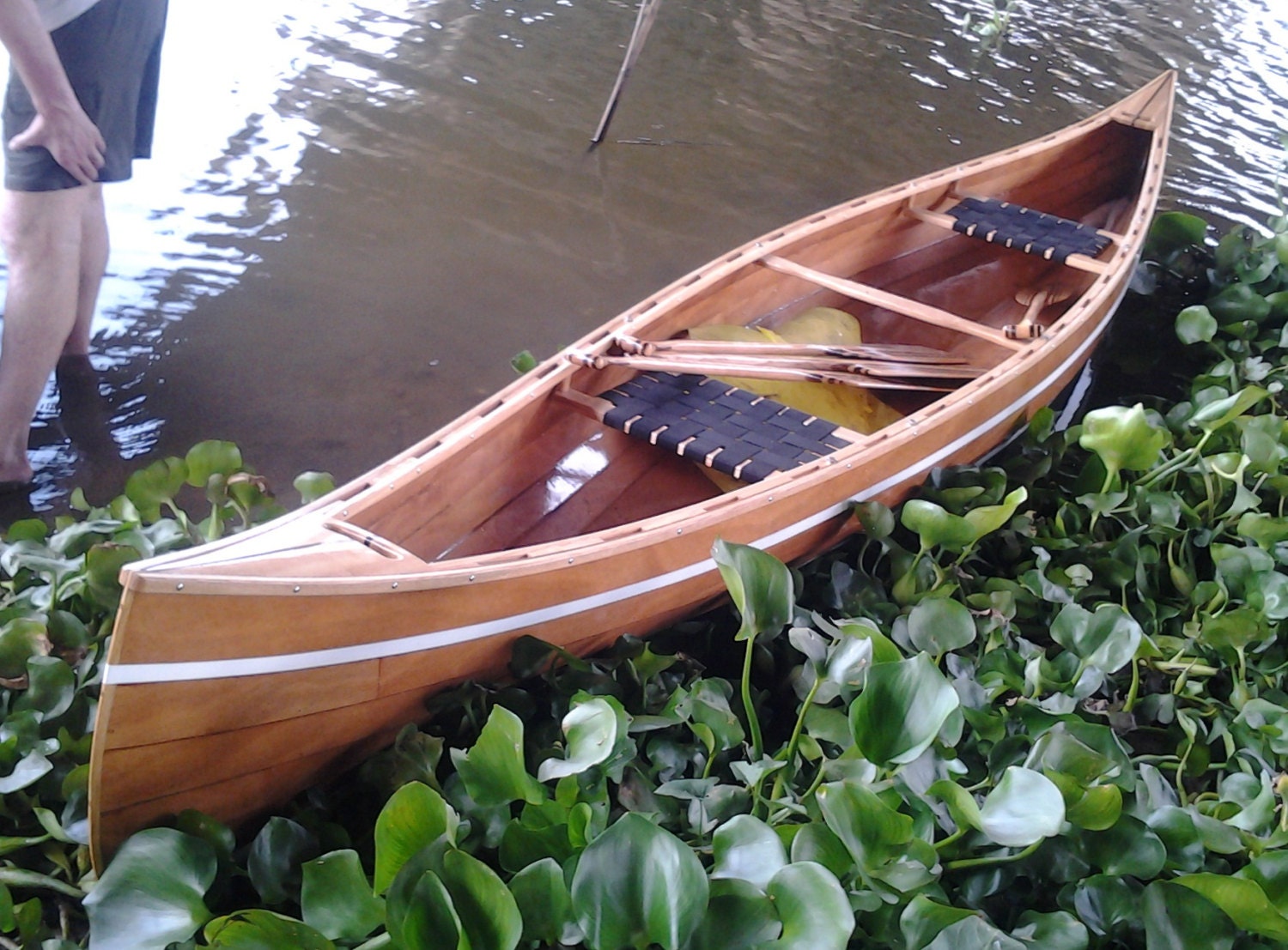 Wooden lapstrake canoe handcrafted from plywood and ash. Enforced by 