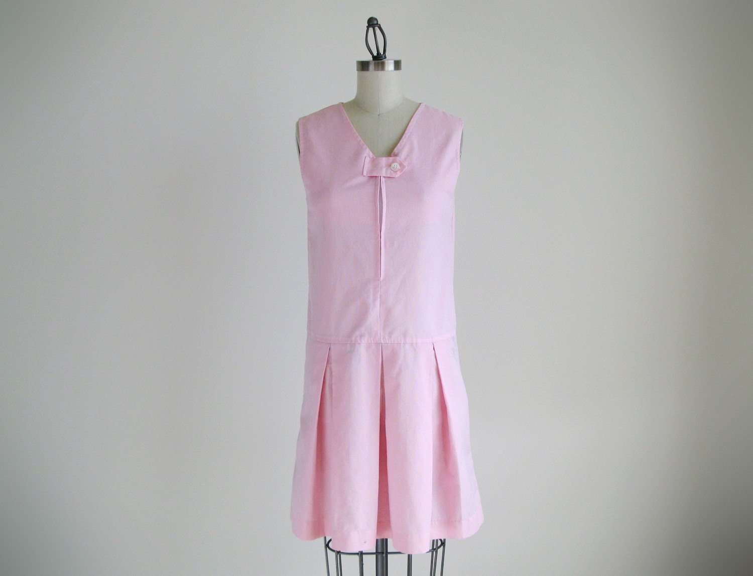 Vintage pink sleeveless dress with pleated skirt.