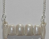 Pearly white vampire fangs necklace