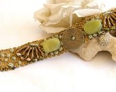 Mintook- Vintage Bracelet, with middle antique copper old coin, 2 green jade stons, verious golden beads and more, all stitched to a ribbon lace.