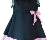 Elegant black, sleeveless dress with a pink bow (2 to 7 years)