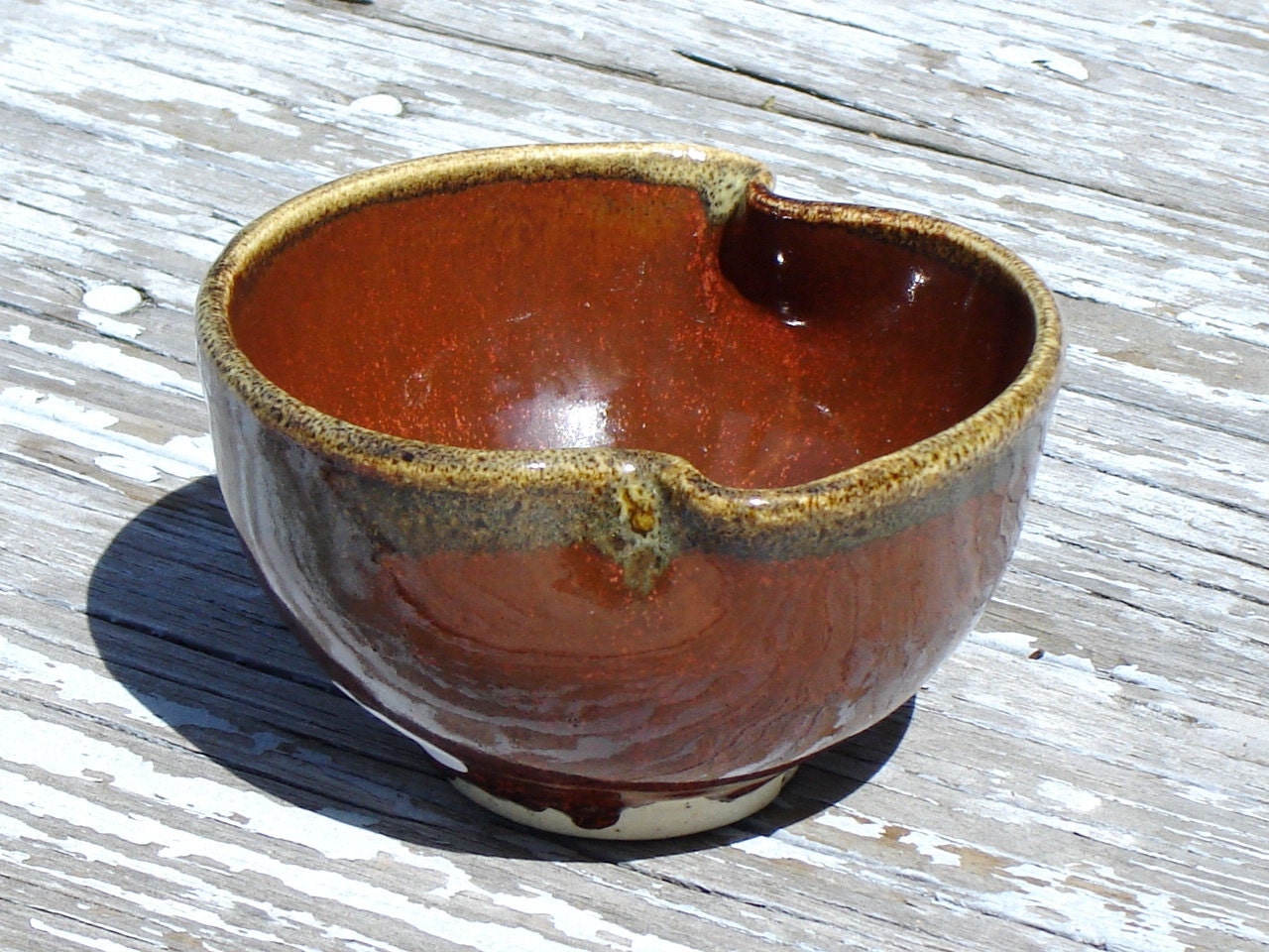 Rust Red Serving Bowl with a Yellow Rim and a Twist