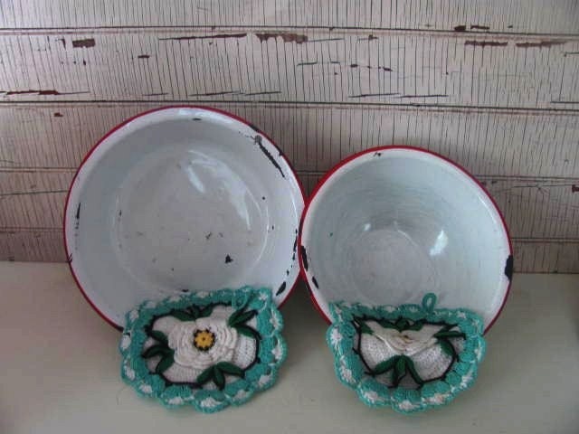 2 vintage crocheted aqua potholders and 2 enamel bowls with red trim straight out of grandma's kitchen