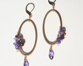 Oval hoop earring in antique brass with purple crystals and seed beads with crystal teardrop