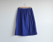 Vintage blue wrap skirt with white piping.