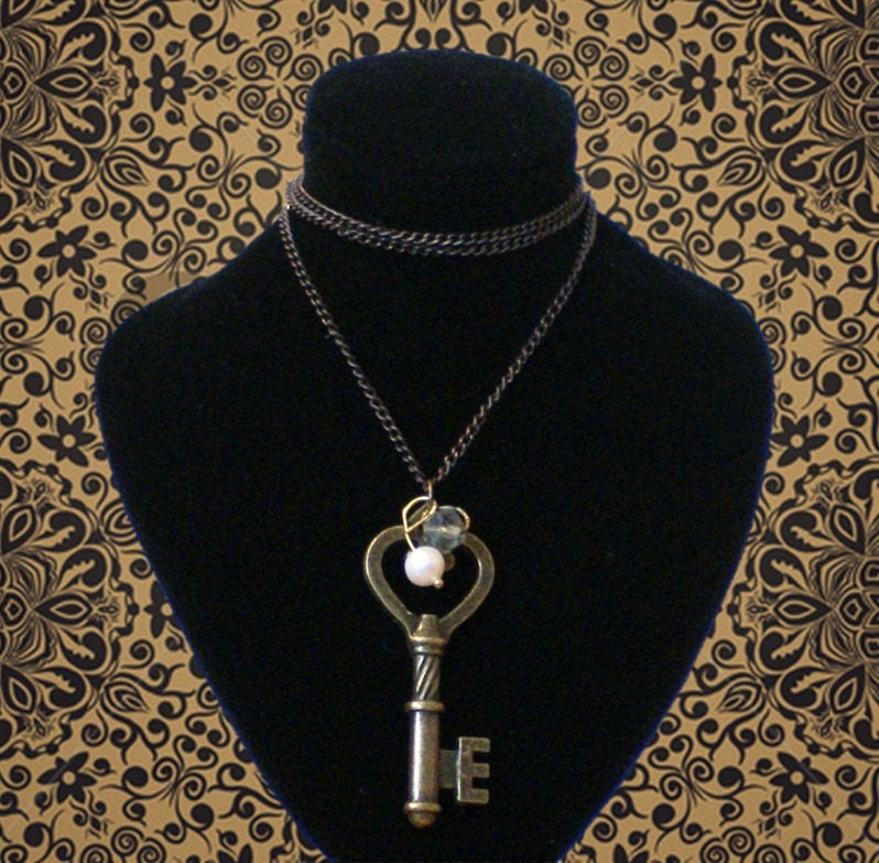 Steampunk style key pendant with faux pearl and smoky grey bead