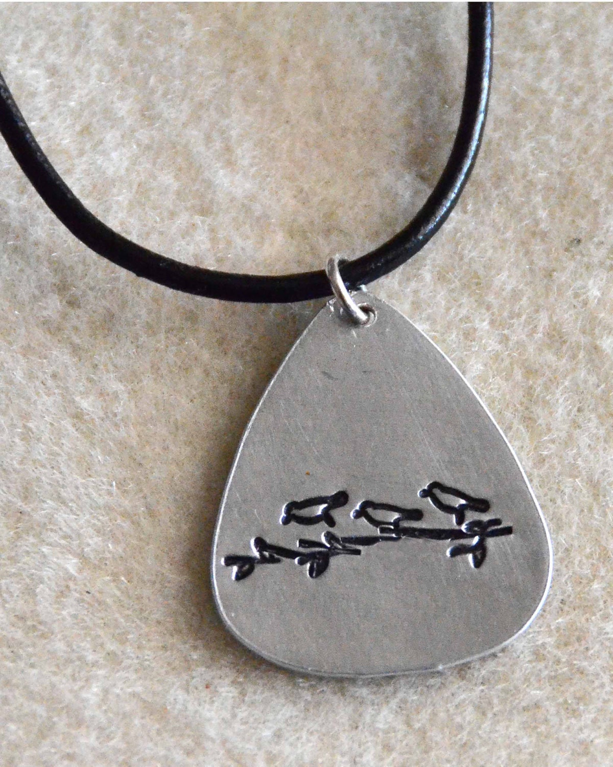 Hand Stamped Guitar Pick Necklace - Aluminum Guitar Pick Hand Stamped With Three Little Birds By Inspired Jewelry Designs