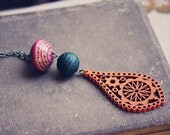 saige.  a colorful beaded wood pendant.