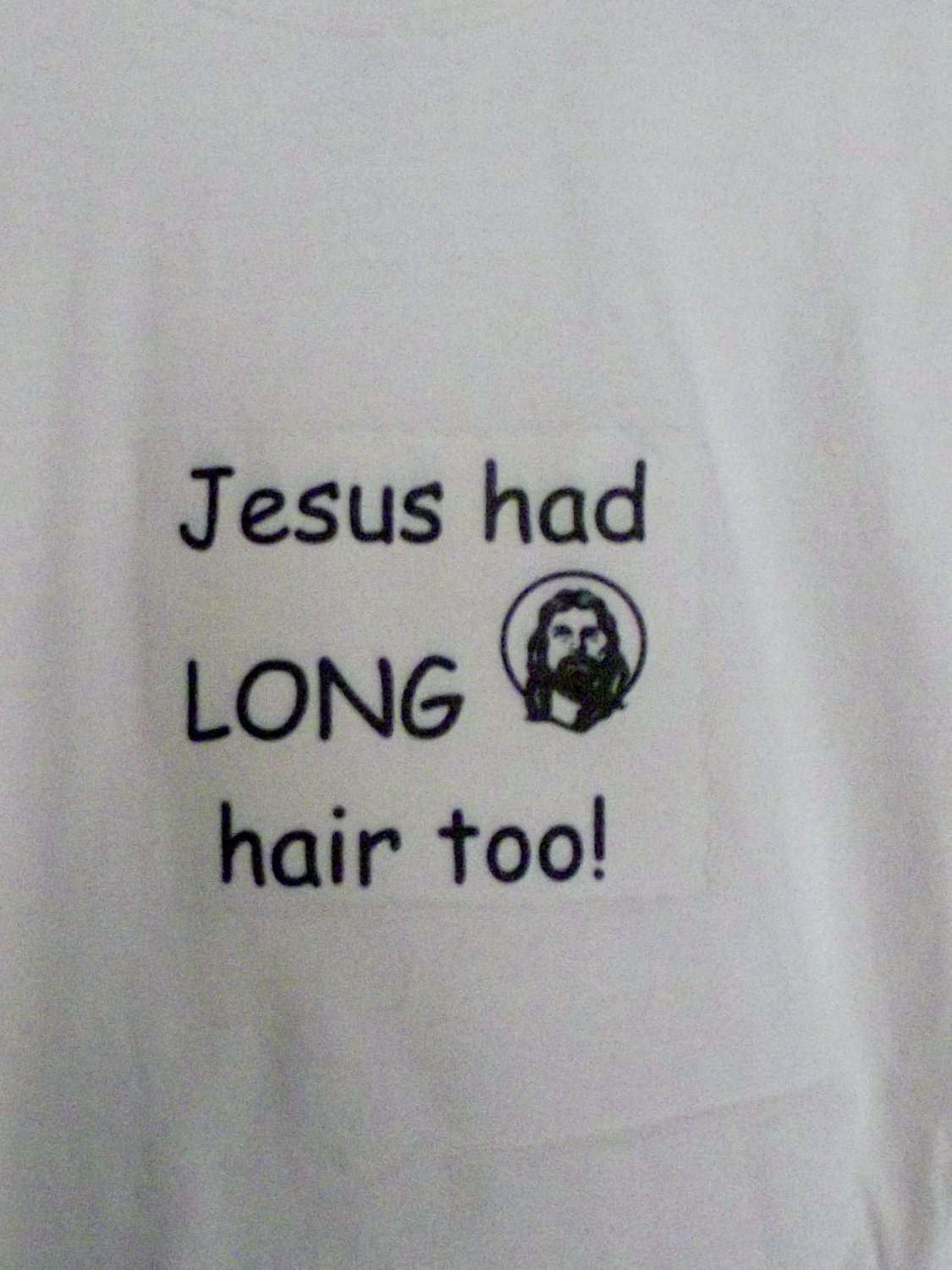Short sleeved t-shirt that says  "Jesus had LONG hair too"