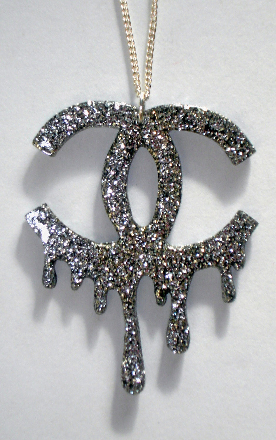 Silver glitter melting Chanel logo necklace