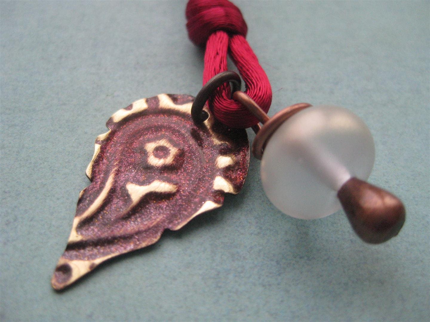 Paisley Flower Embossed Vintaj Brass And Cranberry Satin Necklace With Glass Charm