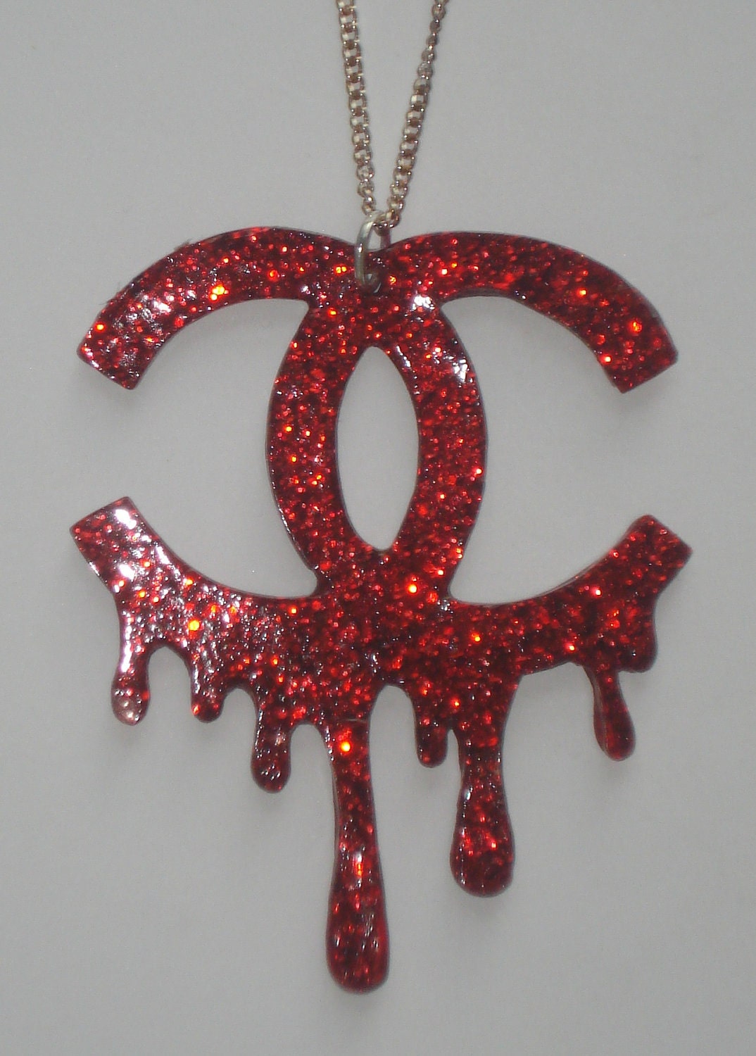 Red glitter bleeding Chanel logo necklace
