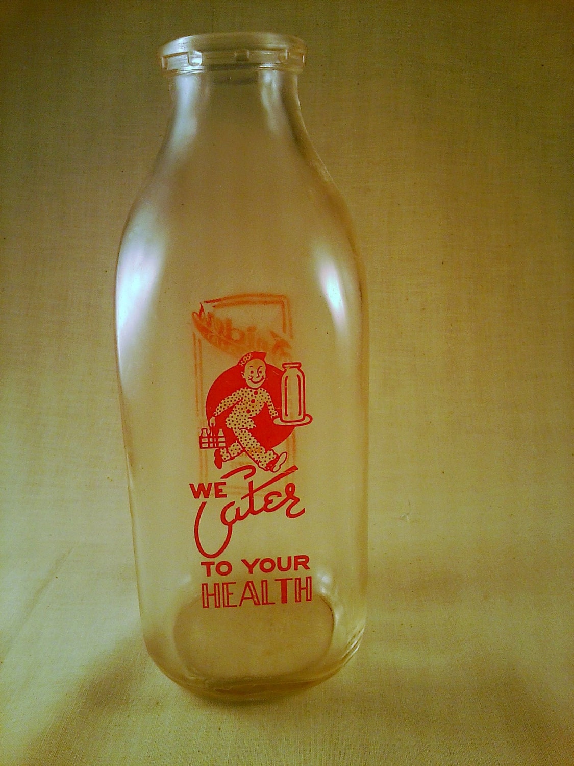 Old antique farmhouse milk bottle-retro and bright orange graphic milk bottle