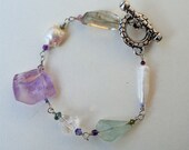 Natural gemstone bracelet consisting of fresh water pearls, amethyst, green amethyst, aquamarine, rock crystal and swarovski crystals