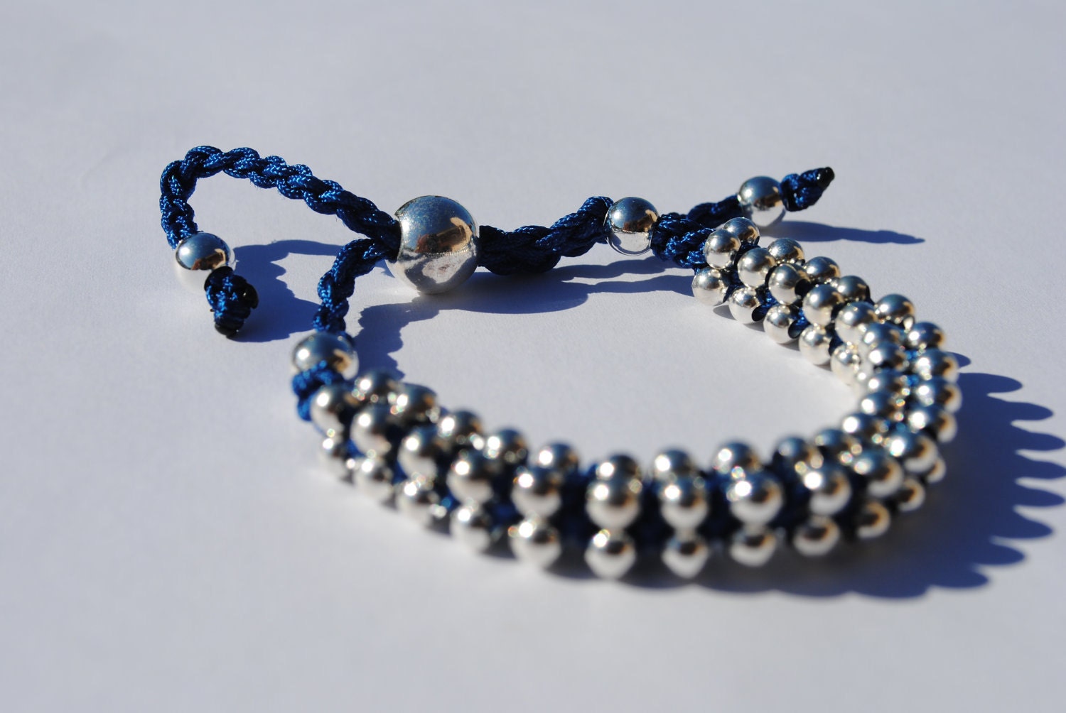 Friendship Ball/Link Bracelet. Silver Plated, woven in Dark Blue Macrame.