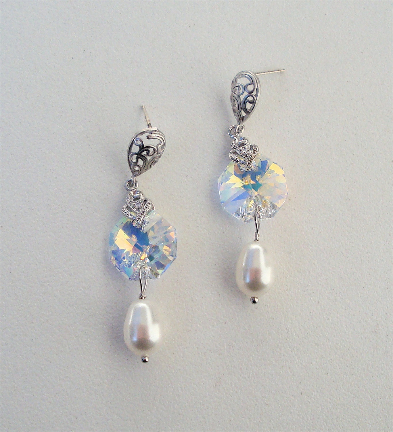 Matte silver vermeil earring with paisley design and sterling silver post, swarovski crystal connection to swarovski crystal pearl.