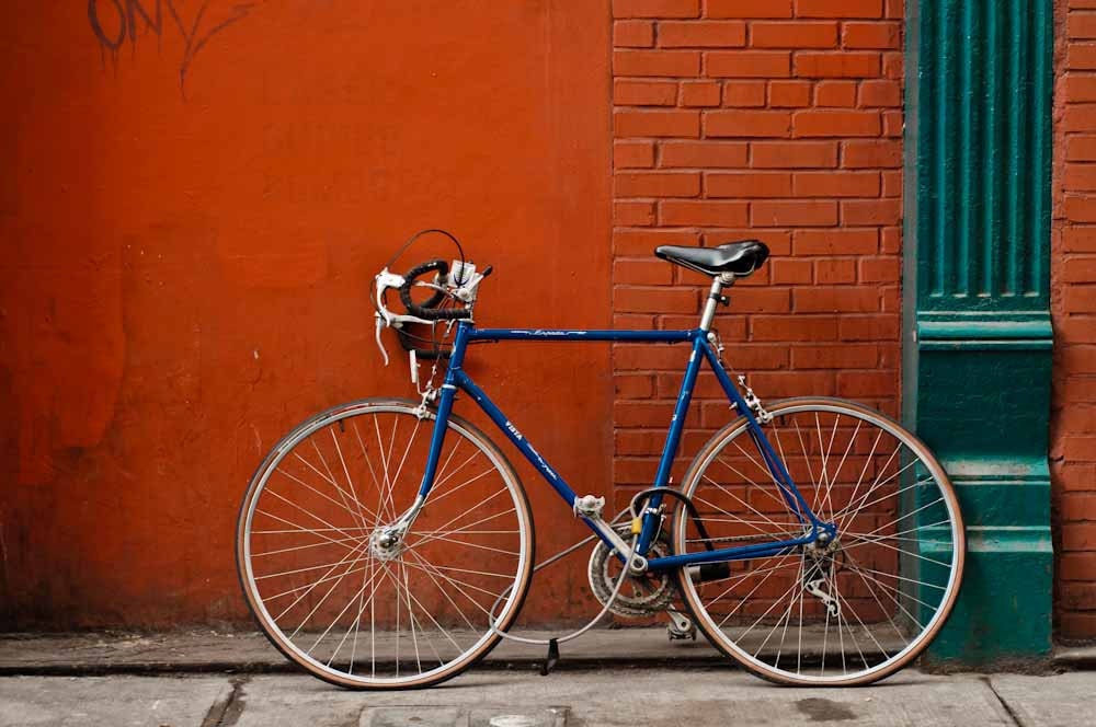 blue bicycle red wall