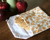 pair of reusable, lined sandwich bags in orange floral & dot stripe
